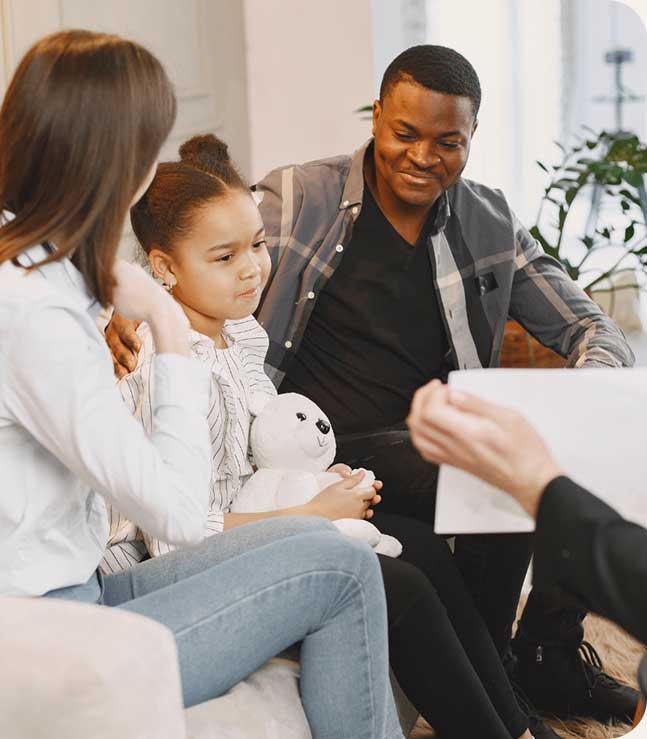 Happy man with wife and child at Family Therapy