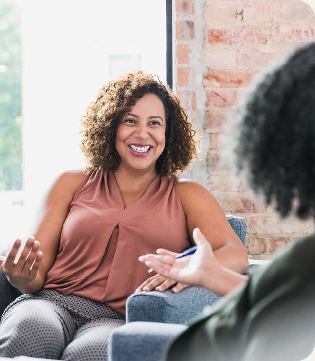 Individual Therapy - lady talking to a therapist and smiling