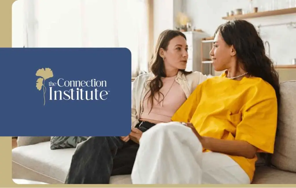 two women talking on a couch