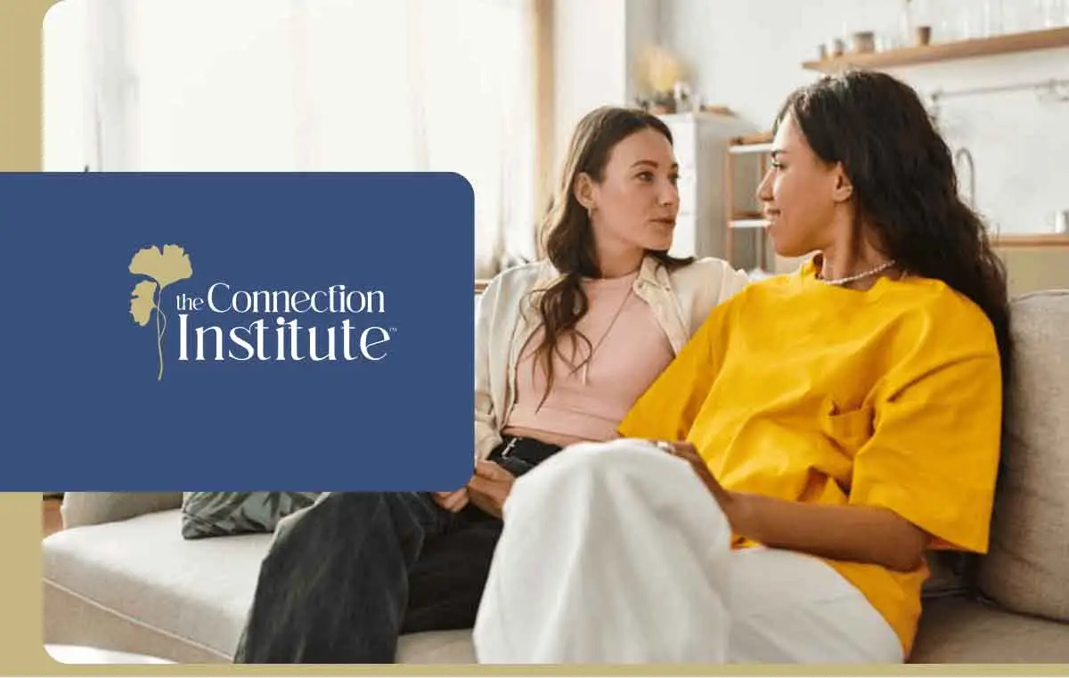 two women talking on a couch